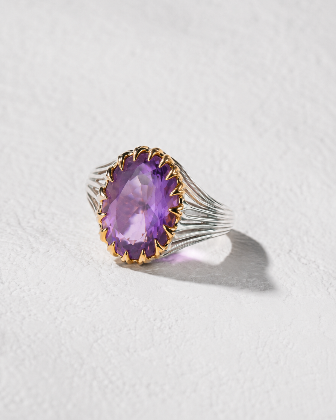 A ring with a large, purple gemstone set in a silver band.